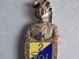 an image of a silver and blue badge on a white surface