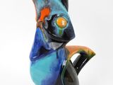 a colorful bird that is sitting on top of a table