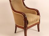 a chair with a striped upholstered back and a wooden frame