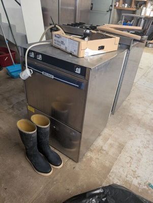 a pair of boots sitting on the floor next to a stove