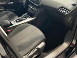 the interior of a car with the door open and the driver ' s seat down