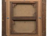 an old wooden picture frame with a shelf on the wall