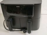 a close up of a small black tv sitting on top of a table