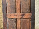 an old wooden cabinet with two doors on it