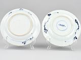 pair of blue and white porcelain plates on stands