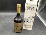 a bottle of wine sitting next to a box of wine