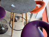 purple and orange stools and a round table in a room