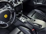 the interior of a black sports car with a steering wheel and dashboard