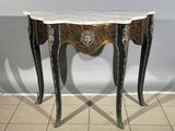 a small table with a marble top on a tiled floor