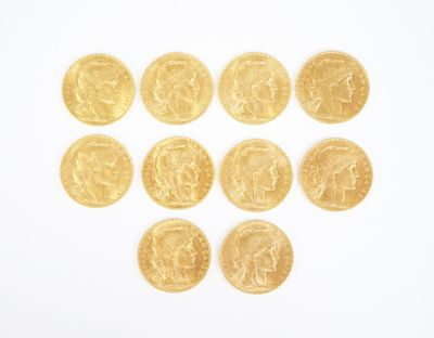 several gold coins arranged in the shape of a heart on a white surface