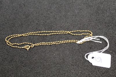 a close up of a necklace with a tag attached to it