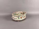 an image of a white bowl with red and green flowers on it