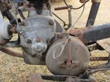 a close up of an old motorcycle with a chain on it