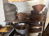 many baskets and bowls on a shelf in a room
