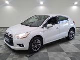 a white citrole parked on a checkered floor in a garage