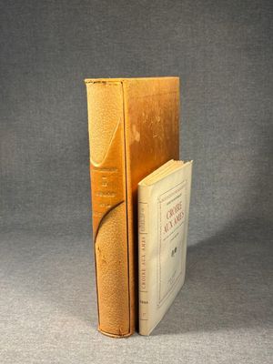 an old book sitting on top of a table next to a book