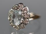 a close up of a diamond ring on a reflective surface