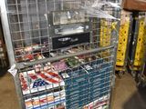 a metal cart with many items in it in a warehouse
