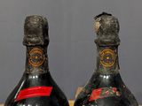 two bottles of wine sitting on top of a table next to each other