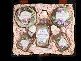 four bottles of perfume in a box on a table