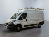 the white van is parked in a large room with a black floor