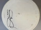 a white plate with writing on it on a table