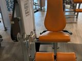 an orange chair in the middle of a gym room