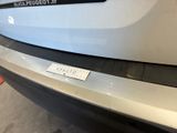 a sticker on the bumper of a white car