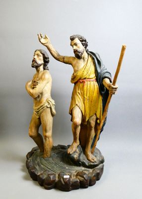 une statue représentant un homme et une femme tenant un bâton