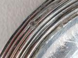 a close up of a silver plate on a table