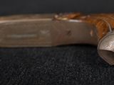 a close up of a cane with a wooden handle on a black surface