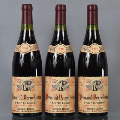 three bottles of wine are lined up on a table