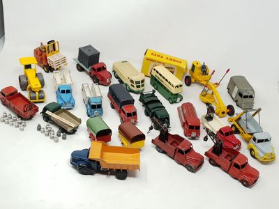 a lot of toy cars and trucks on a white surface