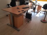 a desk with a monitor, keyboard, mouse, and other items on it