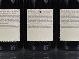 three bottles of wine sitting on top of a table next to each other