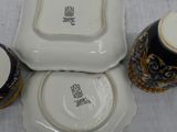 three plates and two cups sitting on a table