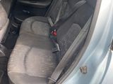 the back seats of a silver car with a black seat belt in the back of it