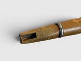 a wooden pipe that is sitting on a white surface