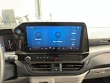 the dashboard of a car with a large screen in the center of it