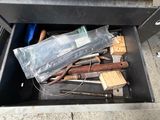 a metal box with tools in it on the ground