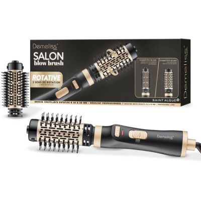 un sèche-cheveux noir et doré posé à côté d'une boîte de brosses à cheveux