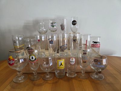 a lot of wine glasses sitting on a wooden table
