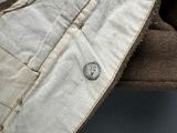 a close up of a hat with a button on it