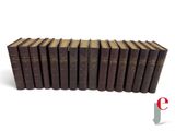 a group of books sitting on top of each other on a white surface