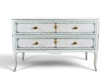 a white and gold chest of drawers on a white background