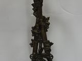 a statue of a bird sitting on a tree branch