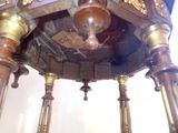 a clock that is sitting on a stand in the room