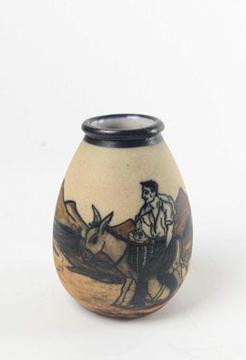a small vase with a picture of a man on a horse