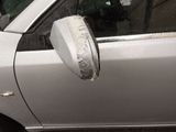 a silver car with a mirror on the side of it