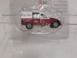 a small red truck in a clear display case